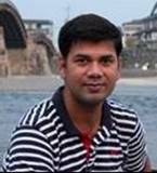 A person standing in front of a body of water

Description automatically generated with medium confidence